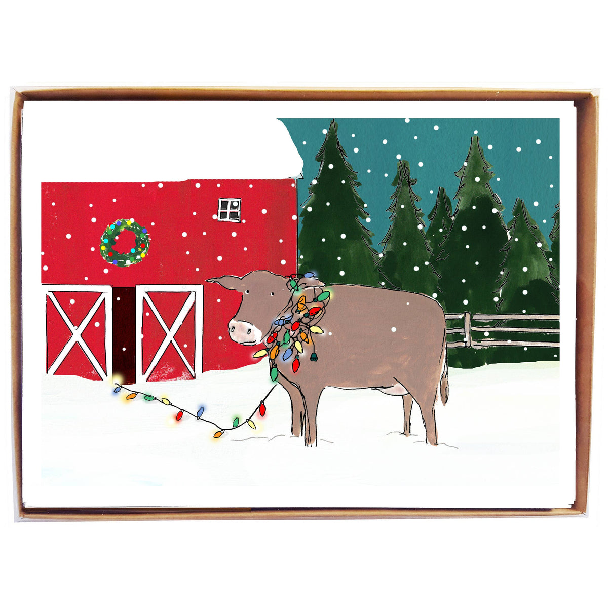 A square greeting card or art print in a wooden frame, featuring a winter farm scene with a brown cow wearing colorful Christmas lights in front of a red barn and evergreen trees under a teal night sky.