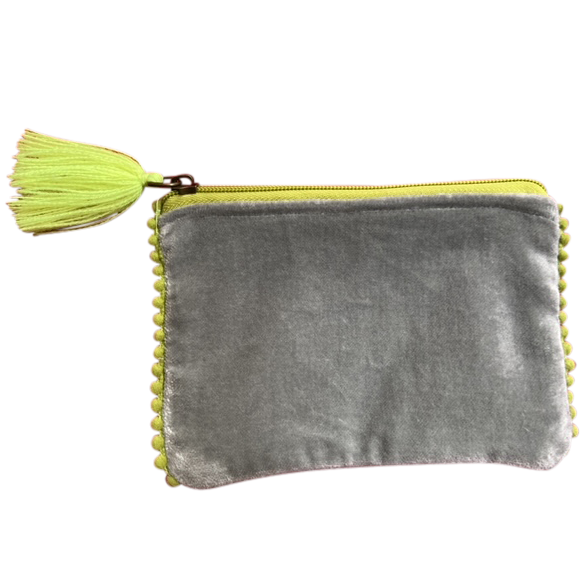 Gray velvet pouch with yellow tassel on a white background