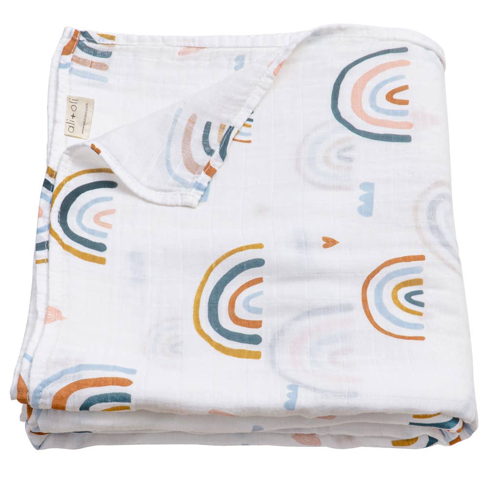 Folded fabric with rainbow pattern on a white background