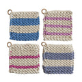 Four knitted potholders with striped patterns on a white background