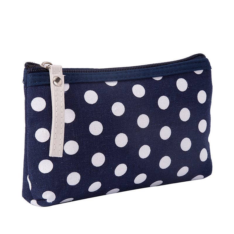 Navy blue pouch with white polka dots on a white background