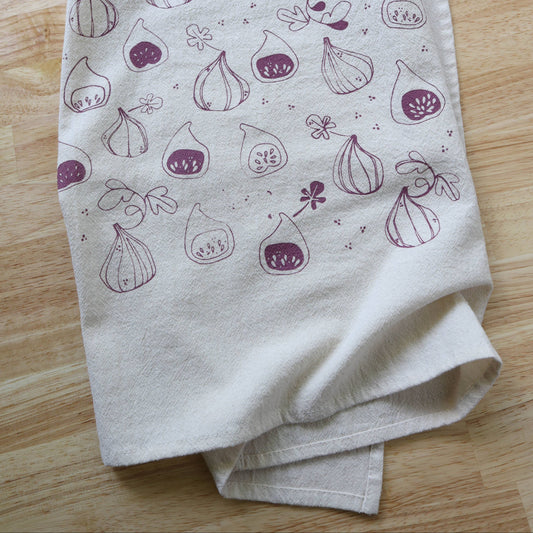 Folded fabric with fig pattern on a wooden surface