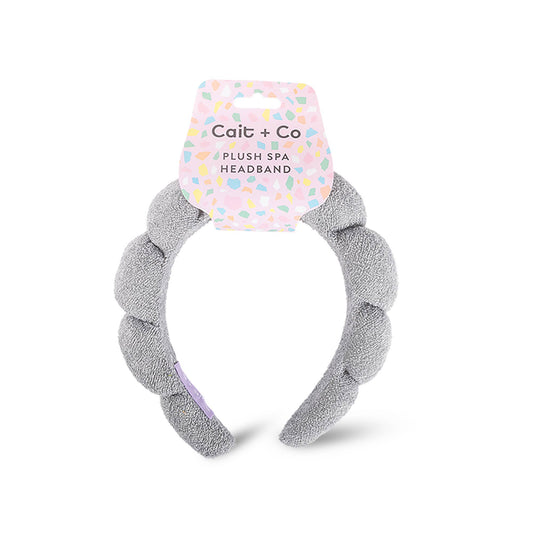 Gray plush spa headband with a Cailt + Co label on a white background