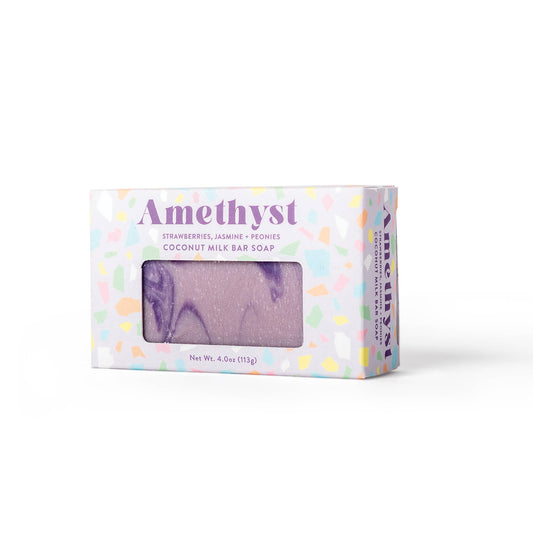 Amethyst Coconut Milk Bar Soap in a pastel speckled box with a clear window showing the lavender-purple marbled soap inside.