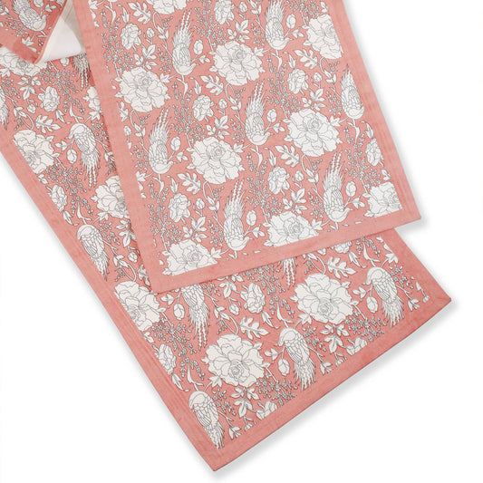 Set of pink floral towels on a white background