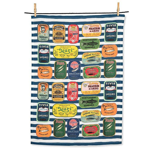 A rectangular kitchen towel with a navy and white striped background, decorated with colorful vintage-style Italian sardine can illustrations. The towel is hung from a black cord with two wooden clothespins at the top, shown against a plain white background.