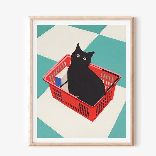 Framed artwork of a black cat in a red basket on a geometric patterned background