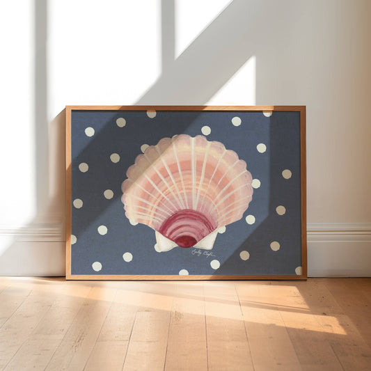 Framed artwork of a shell on a polka dot background in a sunlit room.