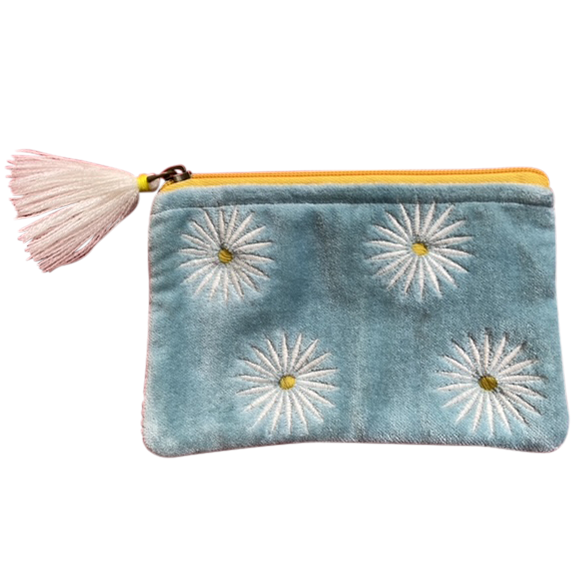 Blue pouch with white floral designs and a pink tassel on a white background