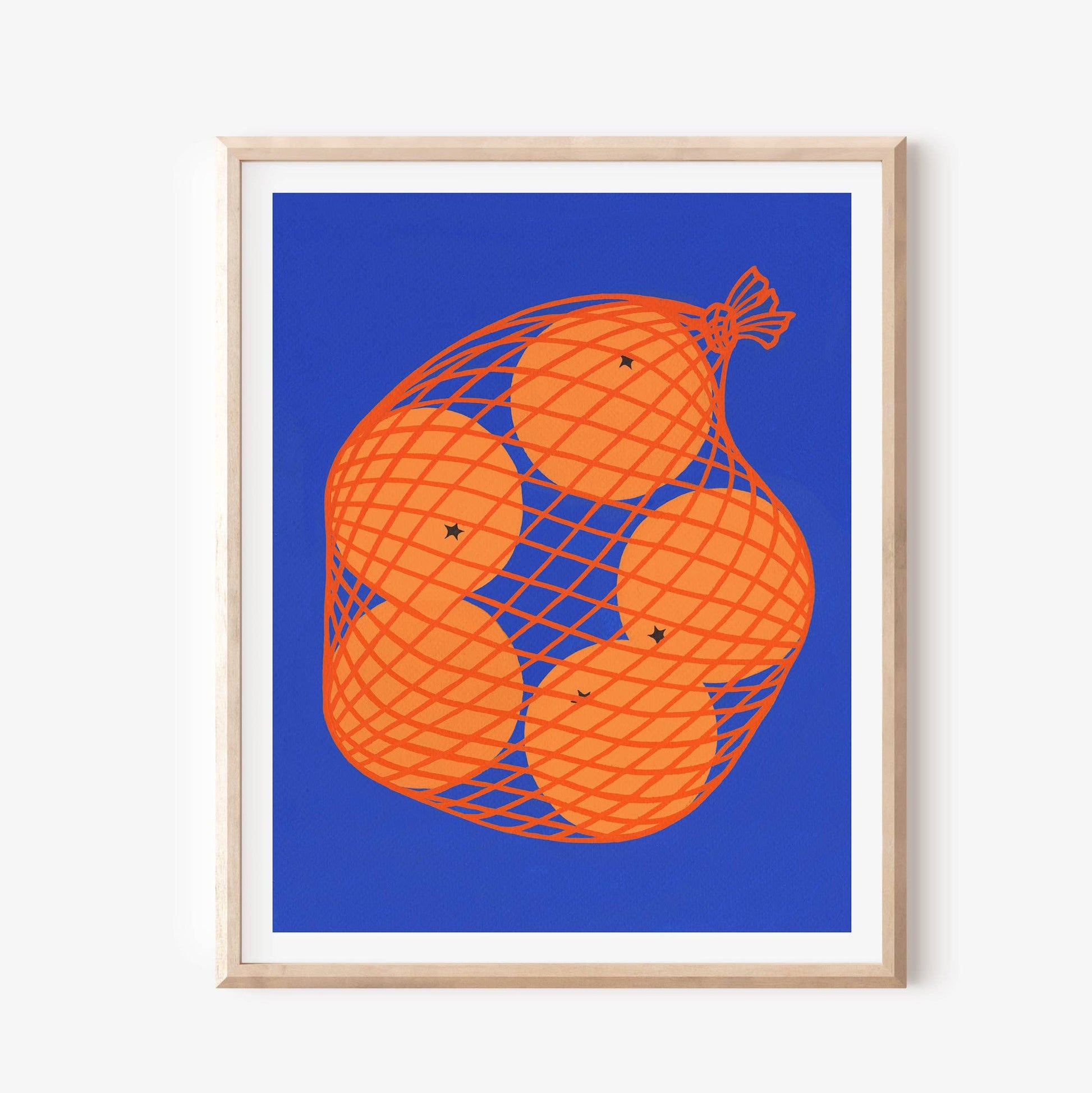 Framed artwork of oranges in a net on a blue background