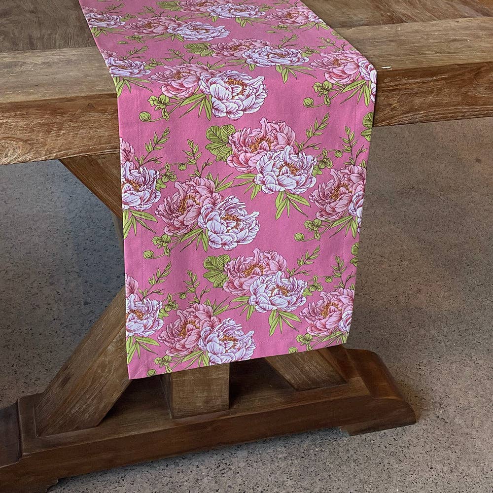 Floral table runner on a wooden table