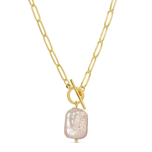 Gold necklace with a large pearl pendant on a white background