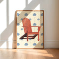 Framed artwork of a red chair on a white background with blue flowers, displayed in a sunlit room.