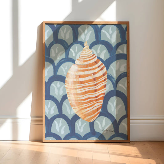 Framed artwork of a shell design on a wall in a bright room with sunlight streaming in.