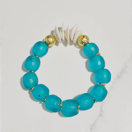 Turquoise beaded bracelet with gold accents on a white background