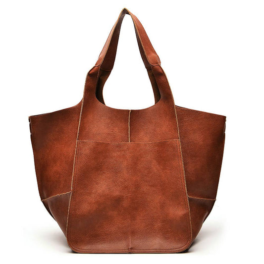 Brown leather tote bag on a white background