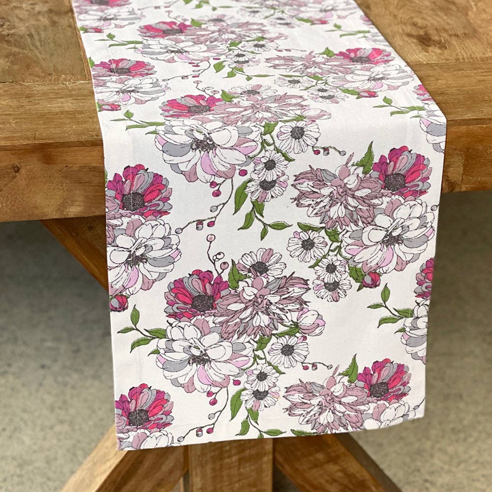 Floral table runner on a wooden table