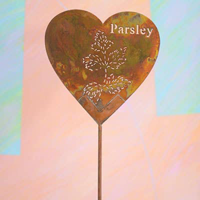 Heart-shaped metal garden marker with 'Parsley' text on a pastel background