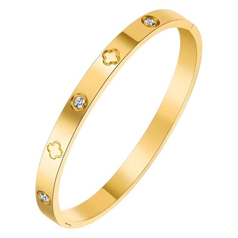 A yellow gold bangle bracelet with four small bezel-set clear stones and four clover-shaped cutouts, shown on a plain white background.