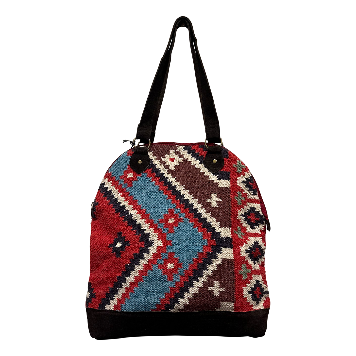 A woven shoulder bag with a geometric kilim pattern in red, blue, brown, and cream, featuring black straps and a black bottom base, shown against a plain white background.