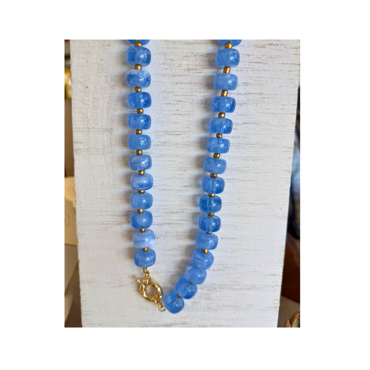 love and clay designs necklace. Chunky Blue beads with gold dividers and clasp. 