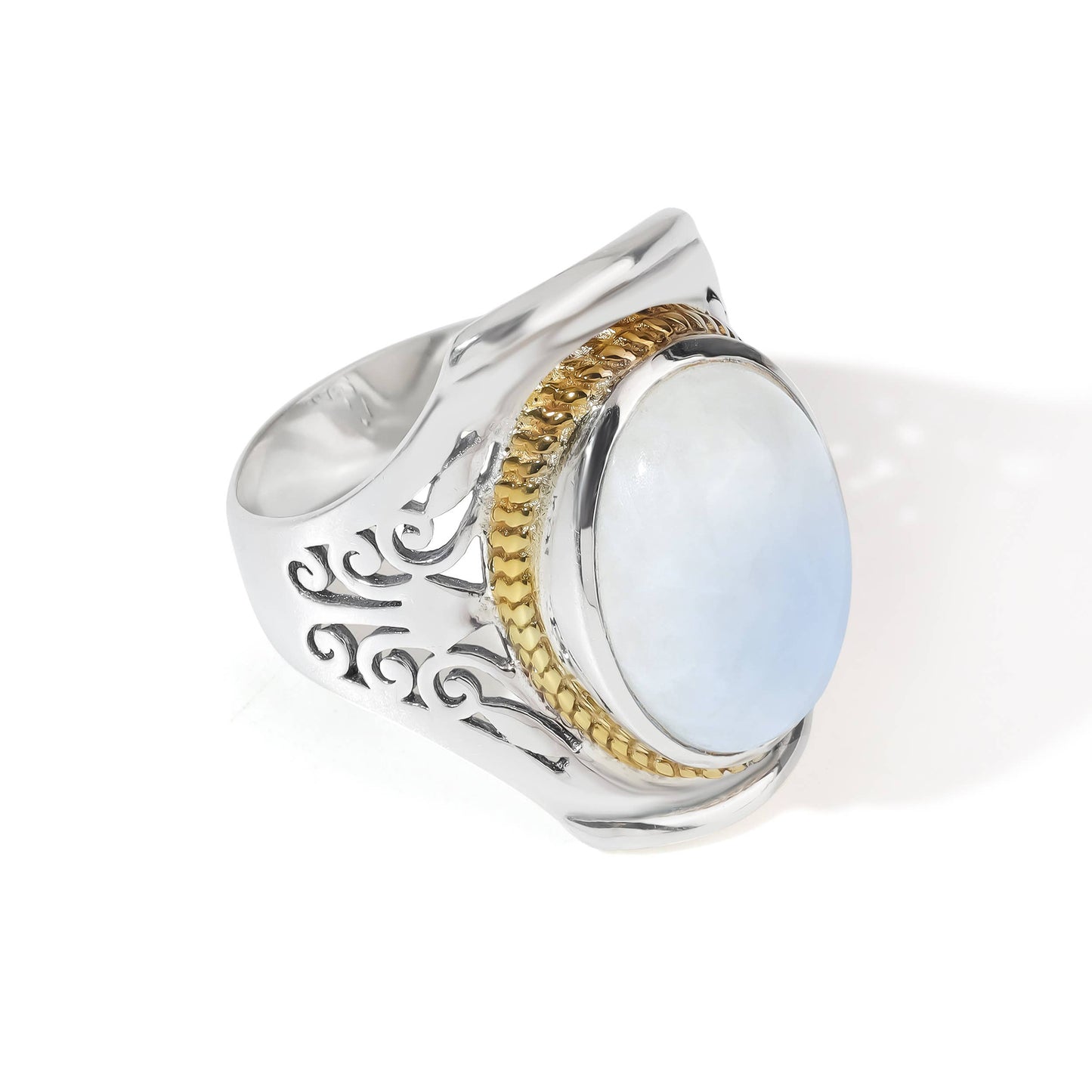 A silver signet ring featuring a large oval light blue moonstone center stone, bordered by a textured gold band and engraved silver details on the shank, set against a plain white background.