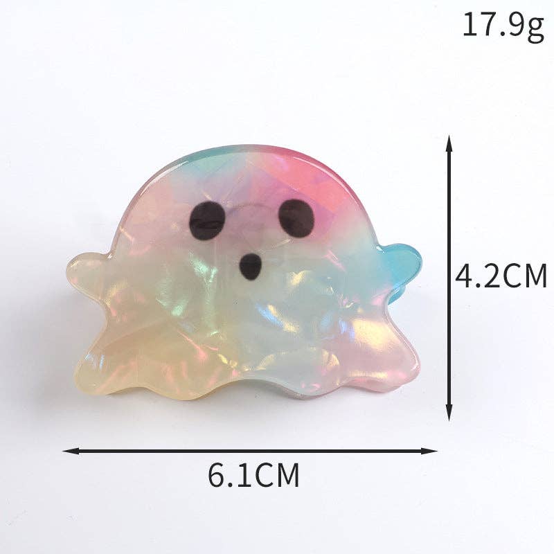 A ghost-shaped iridescent resin hair claw clip with black eyes and mouth, shown with dimension markings of 6.1cm width, 4.