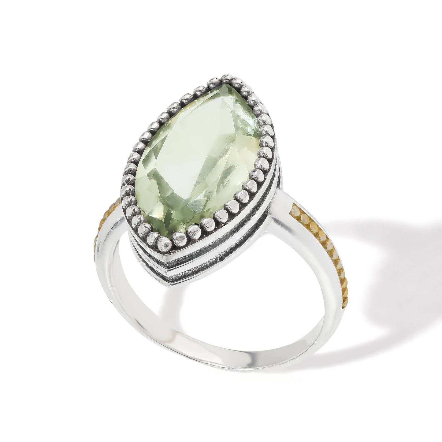 Ring with a green gemstone on a white background