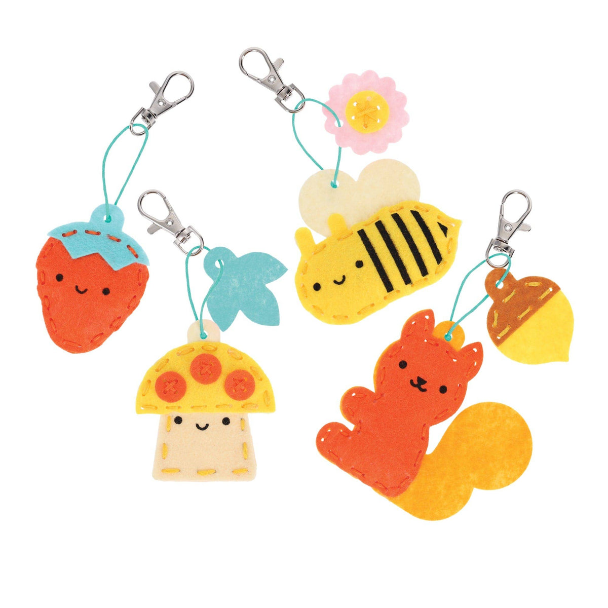 Set of colorful keychains shaped like a strawberry, starfish, mushroom, bee, and squirrel on a white background.