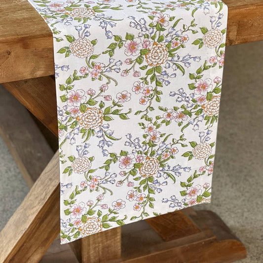 Floral patterned table runner on a wooden table